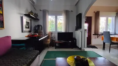 a living room with a couch and a table at Long-Stay Family & Work Oasis -20 min to Center & Sea in Piraeus