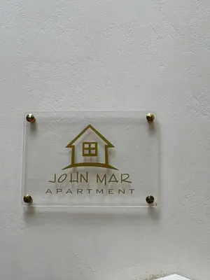 a sign on a wall that says join mar apartment at JOHNMAR apartment in Athens