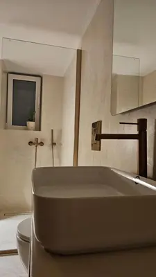a bathroom with a large tub and a toilet at Triton apartment in Athens