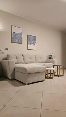 a living room with a couch and a table at Triton apartment in Athens
