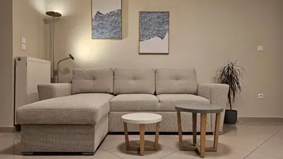 a living room with a couch and two tables at Triton apartment in Athens
