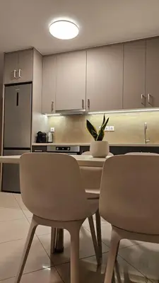 a kitchen with a table and chairs and a refrigerator at Triton apartment in Athens
