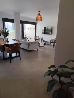a living room with a couch and a table at Αriadne in Porto Rafti