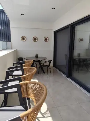 a room with chairs and a table on a balcony at Αriadne in Porto Rafti