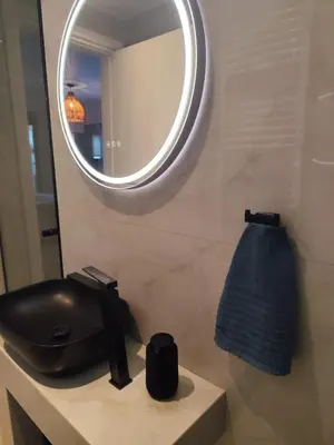 a bathroom with a black sink and a mirror at Αriadne in Porto Rafti