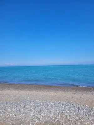 an empty beach with the ocean in the background at Aghia Marina, Aegina Studio in Aegina Town