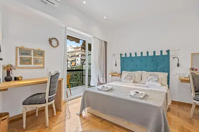 a bedroom with a bed and a table and chairs at h2h Kalypso #Luxury smART, hi-tec, with parking, in 1'metro in Piraeus