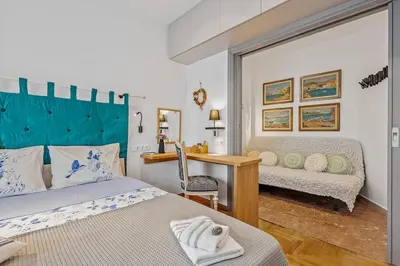 a bedroom with two beds and a desk and a table at h2h Kalypso #Luxury smART, hi-tec, with parking, in 1'metro in Piraeus