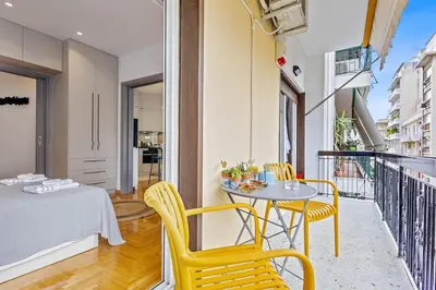 a small balcony with a table and chairs on a balcony at h2h Kalypso #Luxury smART, hi-tec, with parking, in 1'metro in Piraeus