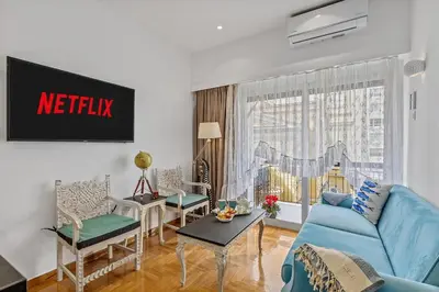 a living room with a blue couch and chairs at h2h Kalypso #Luxury smART, hi-tec, with parking, in 1'metro in Piraeus