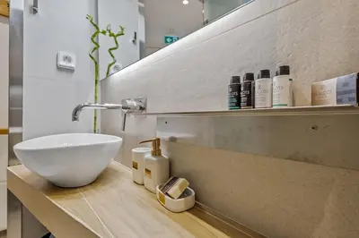 a bathroom with a bowl sink on a counter at h2h Erato #Luxury, tech, smART with parking, in 1' metro in Piraeus