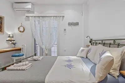 a bedroom with a bed with towels on it at h2h Erato #Luxury, tech, smART with parking, in 1' metro in Piraeus