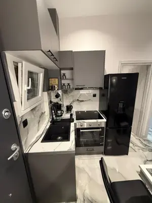 a kitchen with a black and white stove top oven at Elegant Escapes 6 in Athens