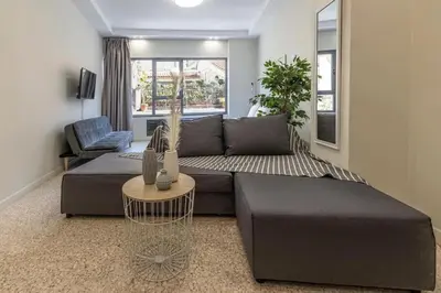 a living room with a couch and a table at Nikiou 11 in Athens