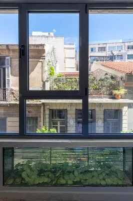 a window with a view of a building at Nikiou 11 in Athens