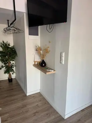 a room with a white wall with a tv on it at Nikiou 11 in Athens
