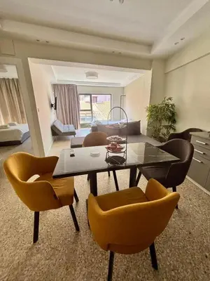 a living room with a dining table and chairs at Nikiou 11 in Athens