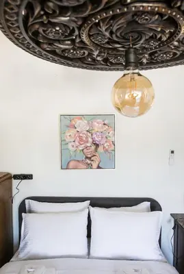 a bedroom with a bed and a chandelier at Athens view suite in Athens