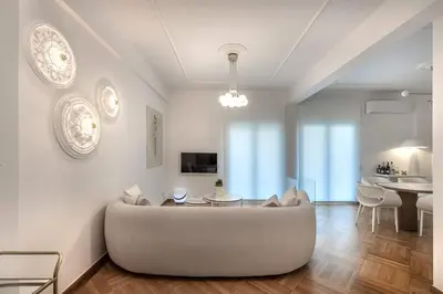 a living room with a couch and a table at Stylish acropolis view apartment in Athens
