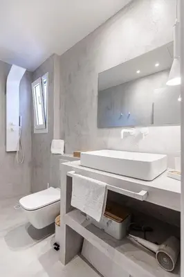 a white bathroom with a sink and a toilet at Stylish acropolis view apartment in Athens