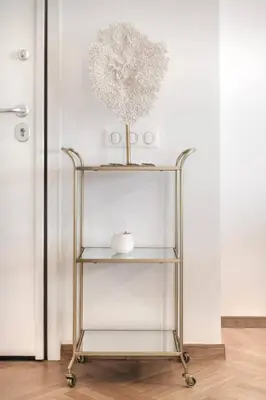 a metal shelf with a vase on a wall at Stylish acropolis view apartment in Athens