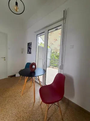 a room with a table and a chair and a window at Acropolis Penthouse - 100Mbps Internet Connection in Athens