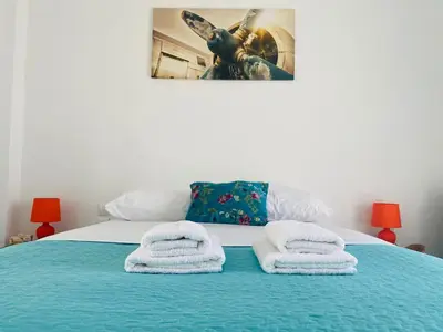 a bedroom with a bed with towels on it at Acropolis Penthouse - 100Mbps Internet Connection in Athens