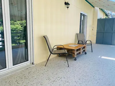 two chairs and a wooden table on a porch at Acropolis Penthouse - 100Mbps Internet Connection in Athens