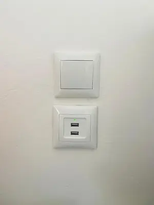 a white lightswitch on a white wall at Acropolis Penthouse - 100Mbps Internet Connection in Athens