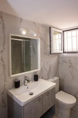 a bathroom with a sink and a toilet at Antigonis Athenian Home in Athens
