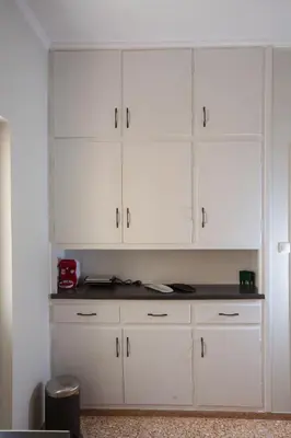 a row of white cabinets in a room at Antigonis Athenian Home in Athens