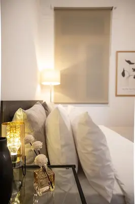 a living room with a couch and a table with pillows at Athens Imperial in Athens