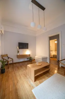 a living room with a couch and a coffee table at Athens Imperial in Athens