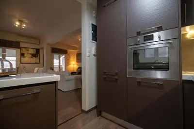 a kitchen with a sink and a oven at Gkyzi Warm Classic Home by ΜΡS in Athens