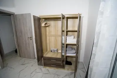 a bathroom with a wooden closet with towels at The Little Yard Downstairs Apt - Goudi by ΜΡS in Athens
