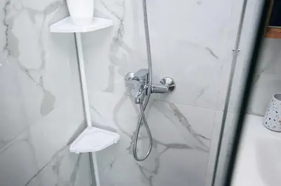 a shower with a shower head in a bathroom at The Little Yard Downstairs Apt - Goudi by ΜΡS in Athens