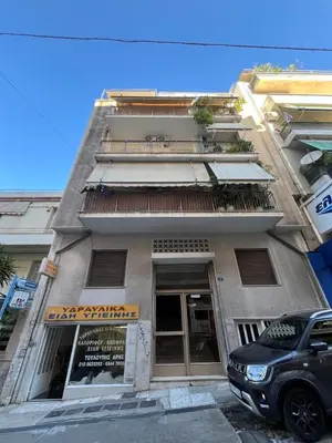 a building with a car parked in front of it at Authentic Kypseli 1 Bedroom in Athens