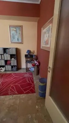 a room with a red wall and a room with a bed at Authentic Kypseli 1 Bedroom in Athens