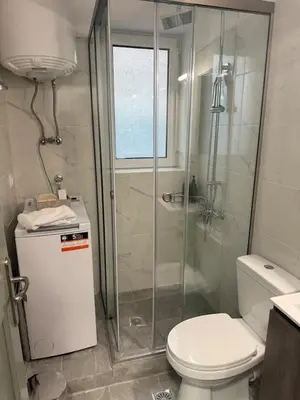 a bathroom with a toilet and a glass shower at Acropolis Traditional Stoney Retreat in Athens