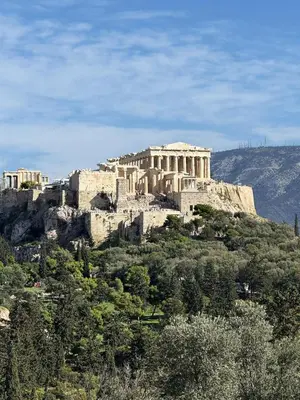 a building on top of a hill with trees at Acropolis Traditional Stoney Retreat in Athens