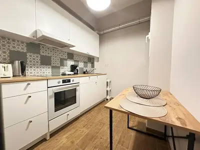 a kitchen with a table with a bowl on it at Cozy Athenian Nest Getaway in Athens