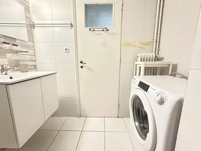 a white laundry room with a washing machine at Cozy Athenian Nest Getaway in Athens