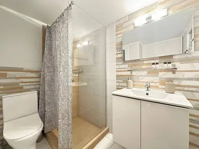 a bathroom with a toilet and a sink and a shower at Cozy Athenian Nest Getaway in Athens