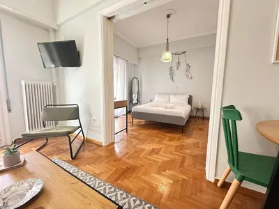 a living room with a bed and a table at Cozy Athenian Nest Getaway in Athens