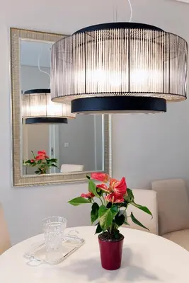 a table with a vase with a flower on it at Estia Residence Acropolis Apartment in Athens