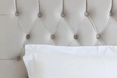 a close up of a bed with a white pillow at Estia Residence Acropolis Apartment in Athens