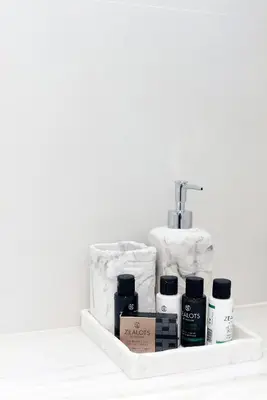 a bathroom shelf with a sink with products on it at Estia Residence Acropolis Apartment in Athens