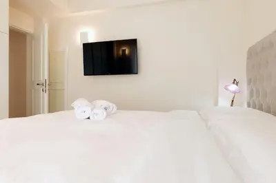 a bedroom with a white bed with towels on it at Estia Residence Acropolis Apartment in Athens