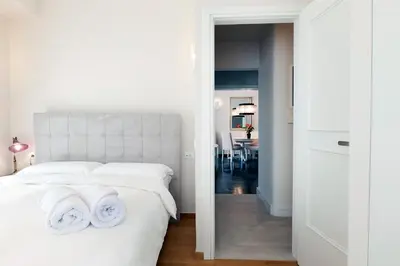 a bedroom with a white bed with two towels on it at Estia Residence Acropolis Apartment in Athens