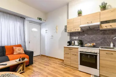 a kitchen and living room with a couch and a table at Studio 35 - Modern & Cozy Studio in Chalandri City Center in Athens